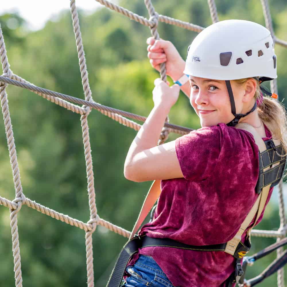 Young woman climbing at HGA Adventure Park
