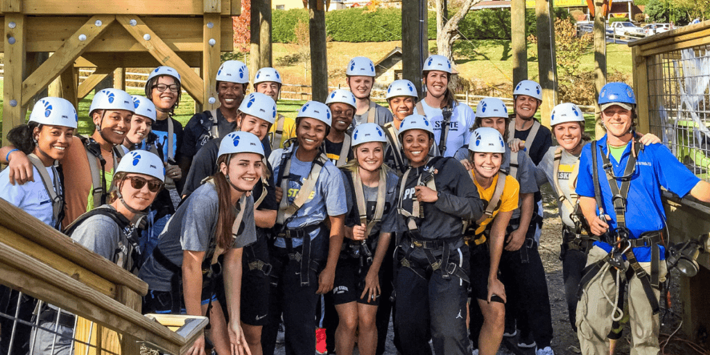 A group of people at an outdoor team building activity