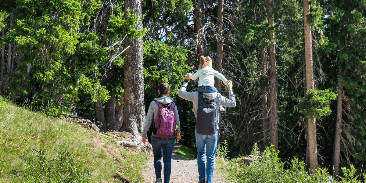 small family walking in the forest