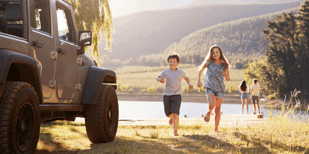 two kids running back to their family vehicle