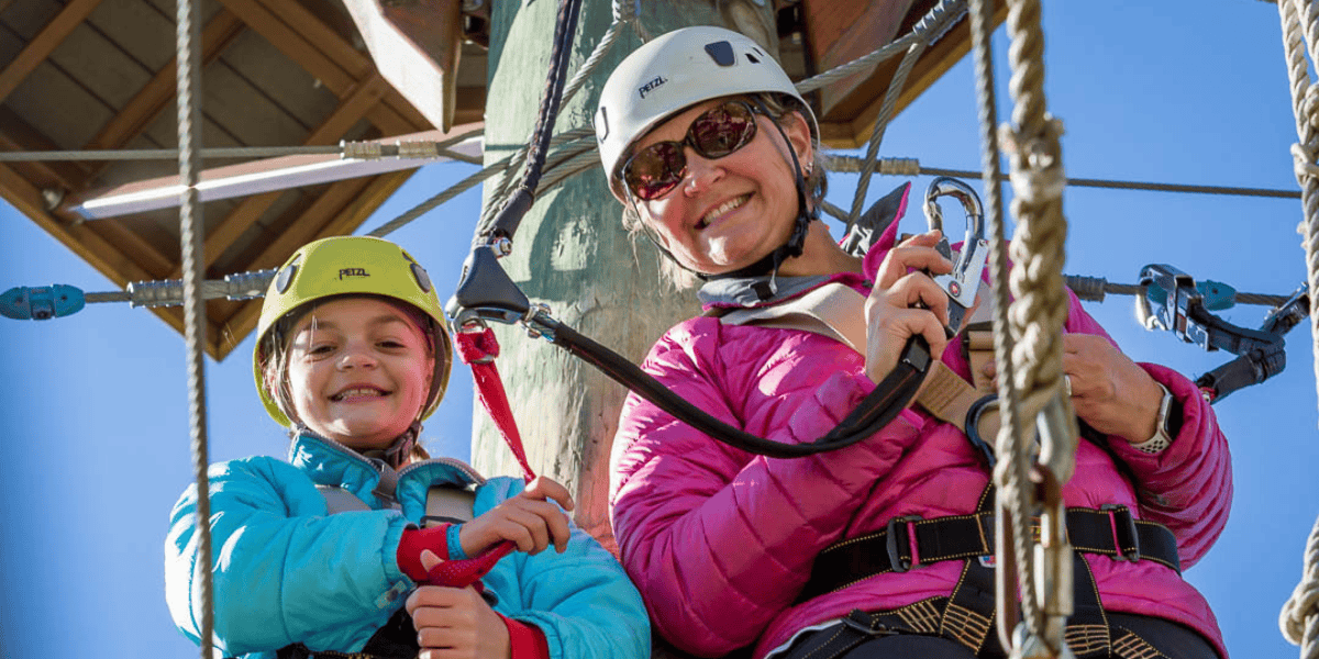 women and child wearing warm clothes to go ziplining