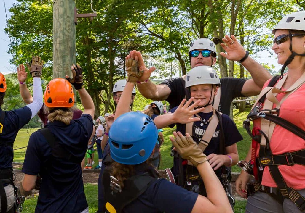 Schools kids on field trip to High Gravity Adventures share high-fives with staff.
