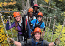 group of people ziplining in the fall